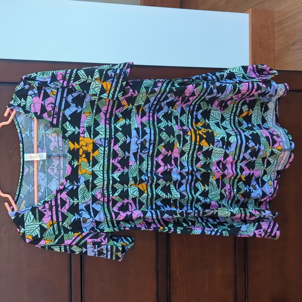 Lularoe tunic shirt size small. Black background with vibrantly colored pattern